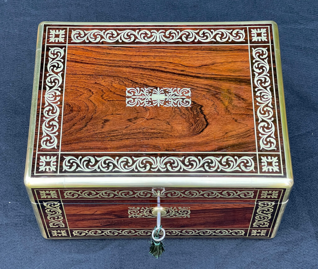 Top view of an Antique Jewellery Box in Rosewood with Scrollwork Brass Inlay.