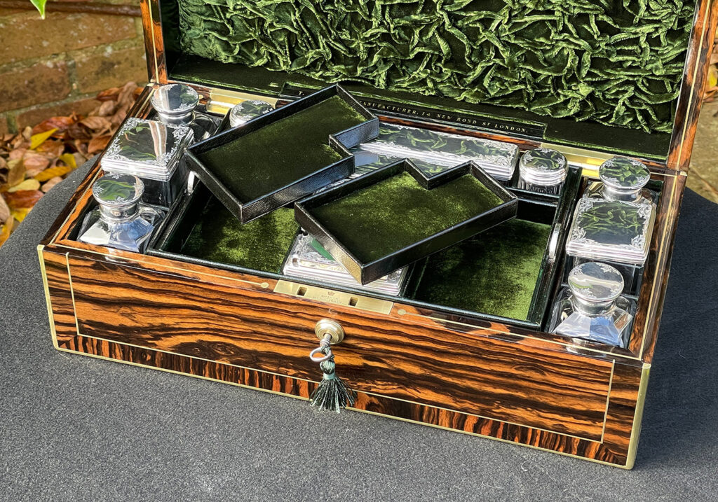 Close up interior view of an Antique Silver Mounted Dressing Case in Calamander, by Thomas Strudwick with the two top trays removed.