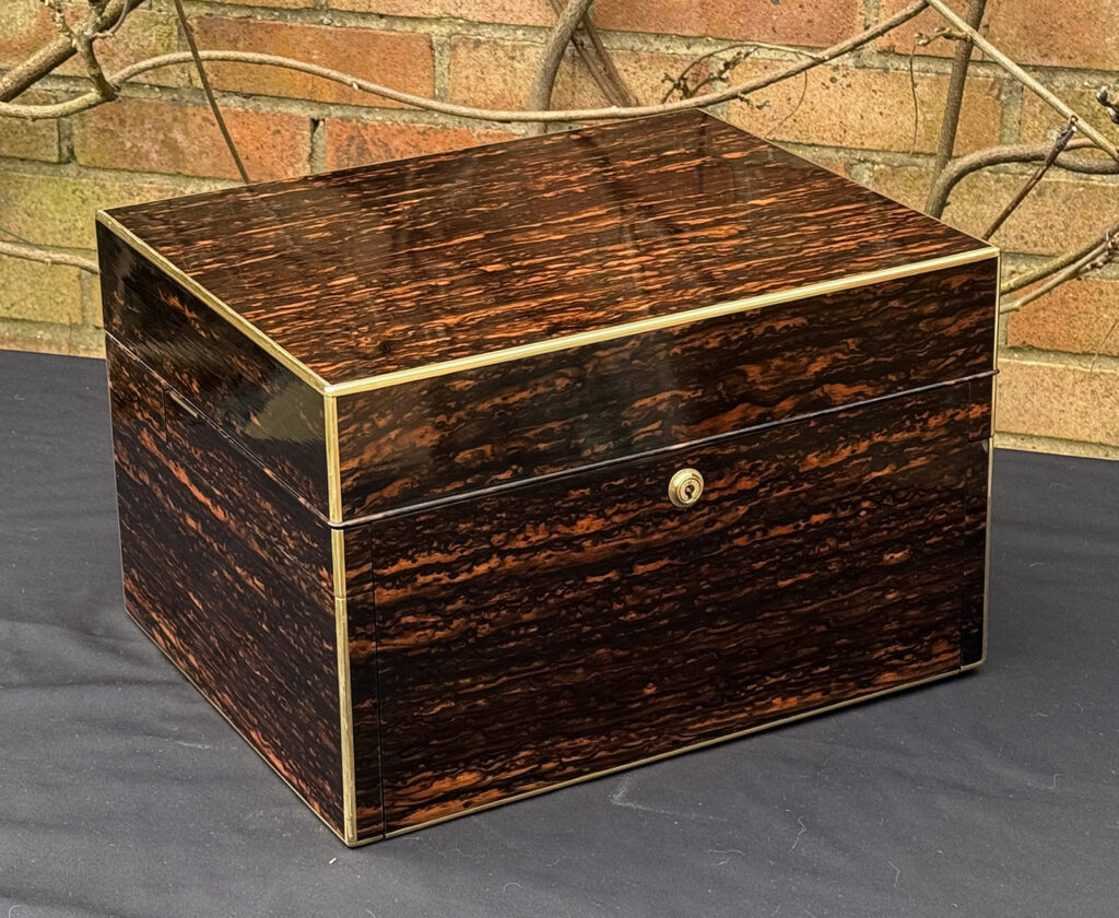 Front left view of an Antique Jewellery Box in Coromandel with Betjemann Patent Automatic Mechanism.