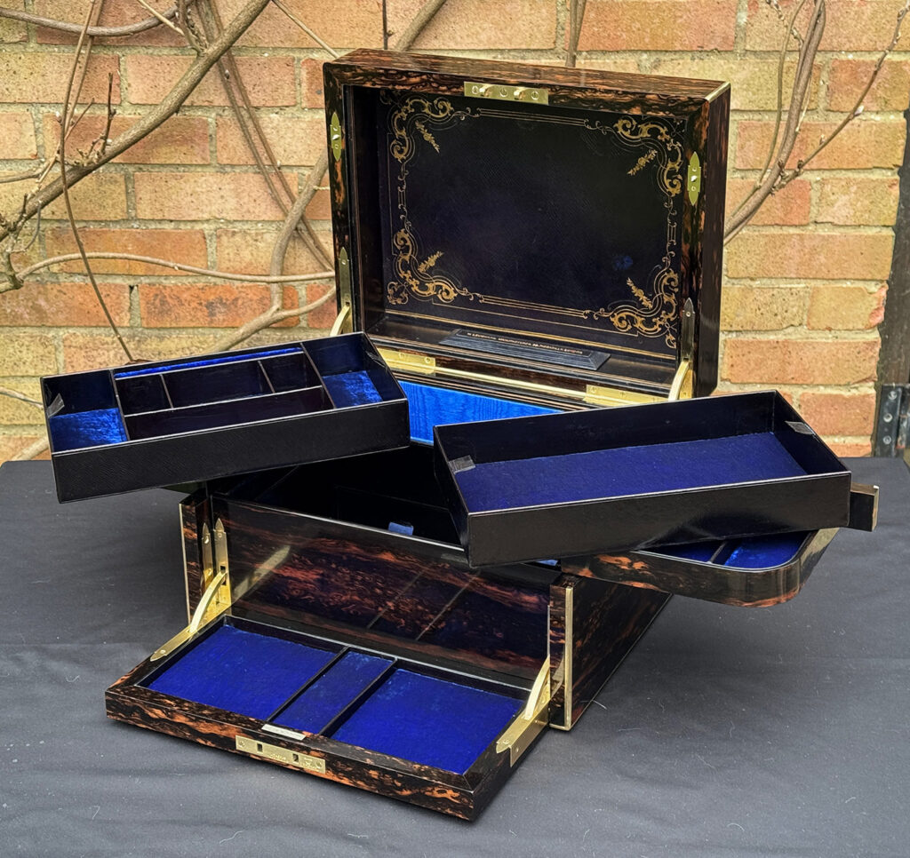 Front open view of an Antique Jewellery Box in Coromandel with Betjemann Patent Automatic Mechanism with two trays removed.