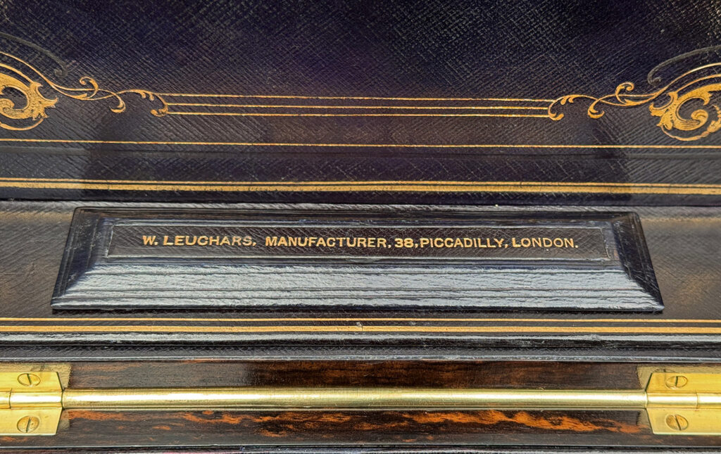 Close up view of William Leuchars makers mark from an Antique Jewellery Box in Coromandel with Betjemann Patent Automatic Mechanism.