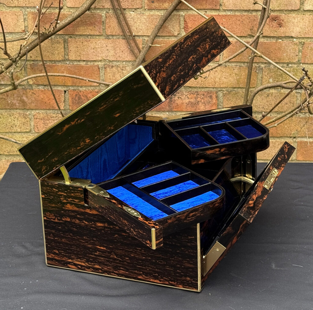 Left side opening view of an Antique Jewellery Box in Coromandel with Betjemann Patent Automatic Mechanism.
