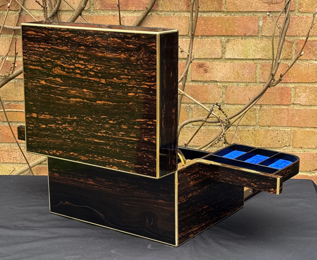 Rear left open view of an Antique Jewellery Box in Coromandel with Betjemann Patent Automatic Mechanism.