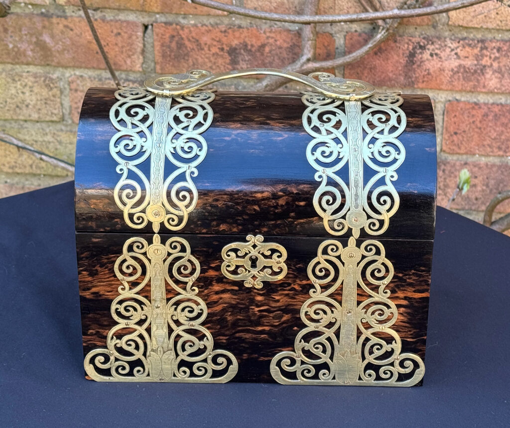 Front view of an Antique Jewellery Box in Coromandel With Engraved Brass Overlay.