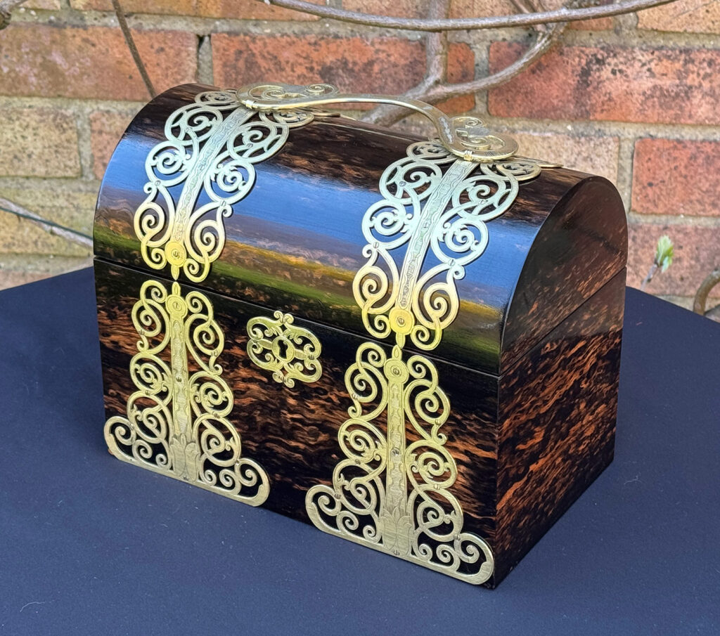 Front right view of an Antique Jewellery Box in Coromandel With Engraved Brass Overlay.