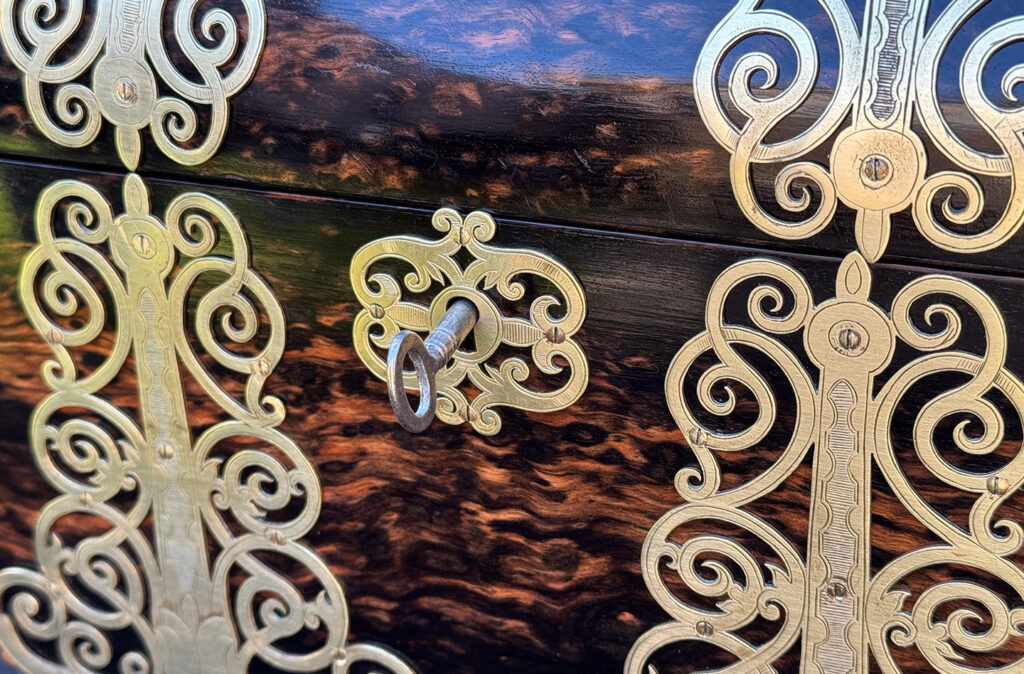 Close up view of an Antique Jewellery Box in Coromandel With Engraved Brass Overlay.