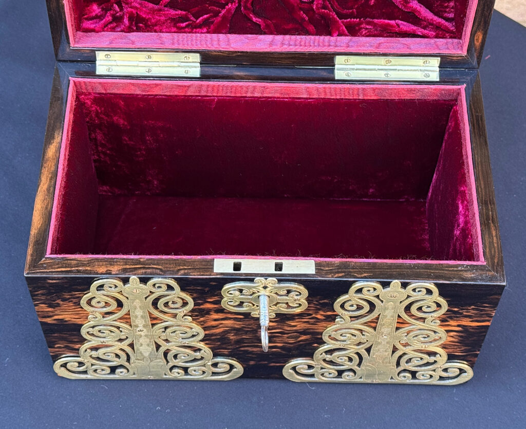Close up internal view of an Antique Jewellery Box in Coromandel With Engraved Brass Overlay.