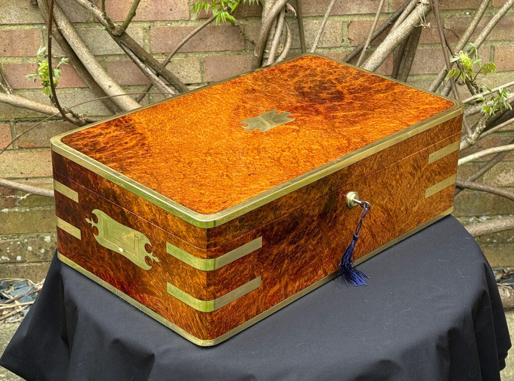 Front left view of an Extra Large Antique Jewellery Box in Solid Amboyna, by Asprey.