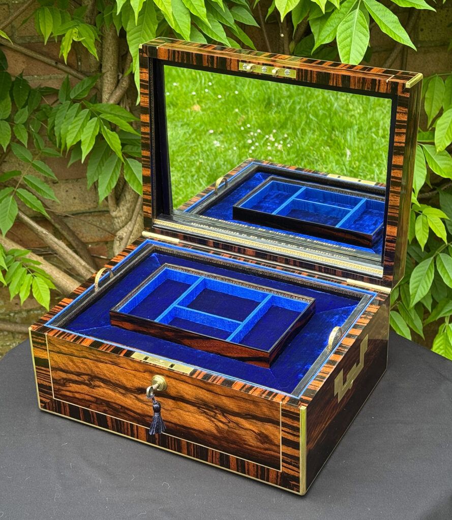 Front right internal view of an Antique Jewellery Box in Calamander, by Edwards with mirror on display.
