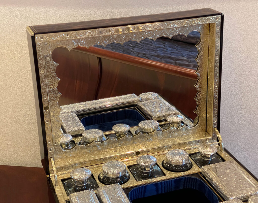 Close up view of the mirror frame from an Antique Silver Mounted Dressing Case in Coromandel, by William Tooke.