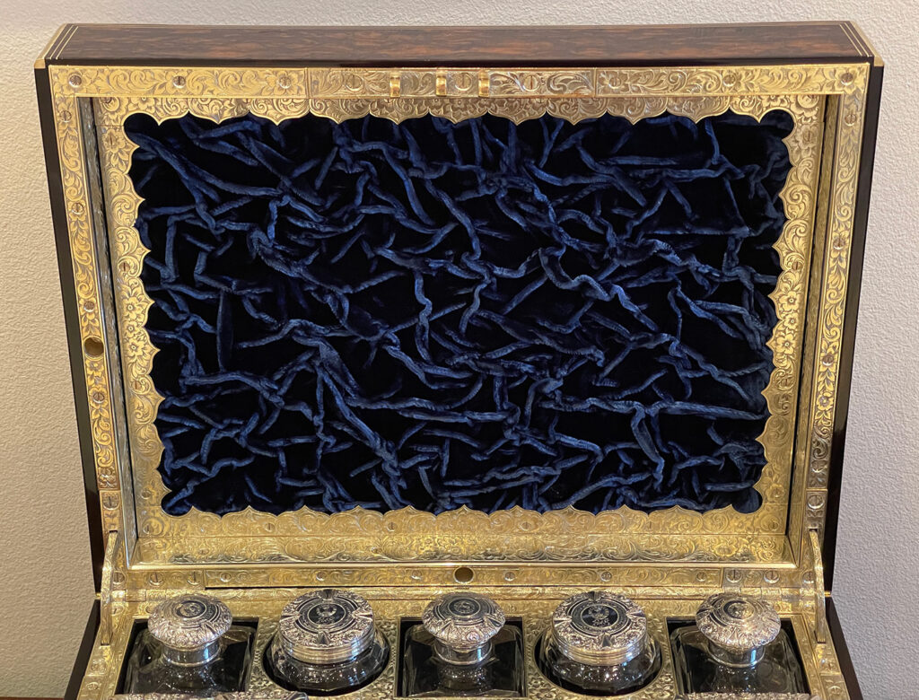 Close up view of the ruched velvet panel from an Antique Silver Mounted Dressing Case in Coromandel, by William Tooke.