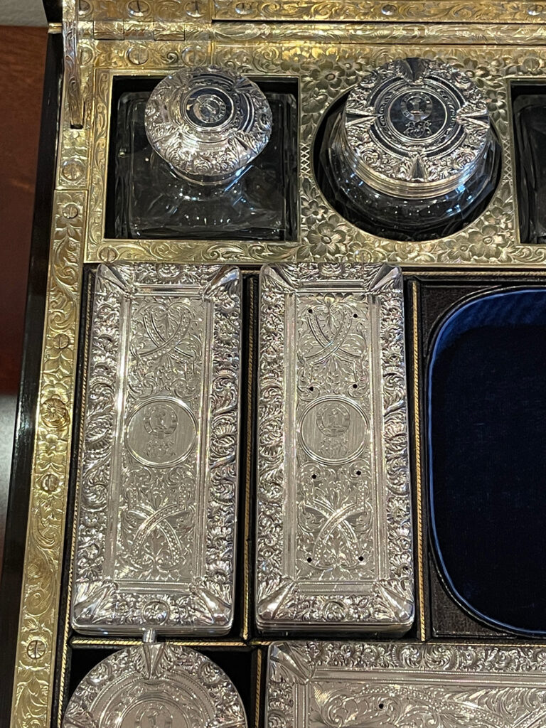 Close up of the engraved silver mounted bottles and jars from an Antique Silver Mounted Dressing Case in Coromandel, by William Tooke.