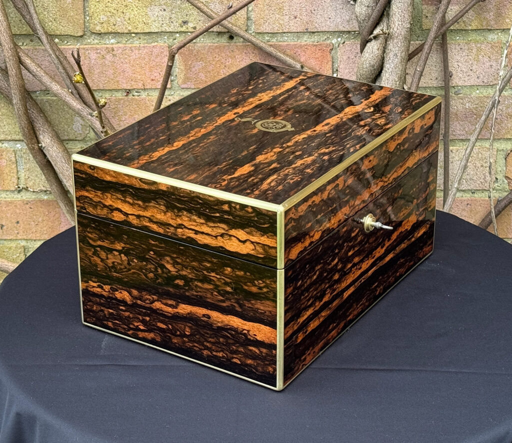 Front left view of an Antique Jewellery Box in Coromandel, by Halstaff and Hannaford.