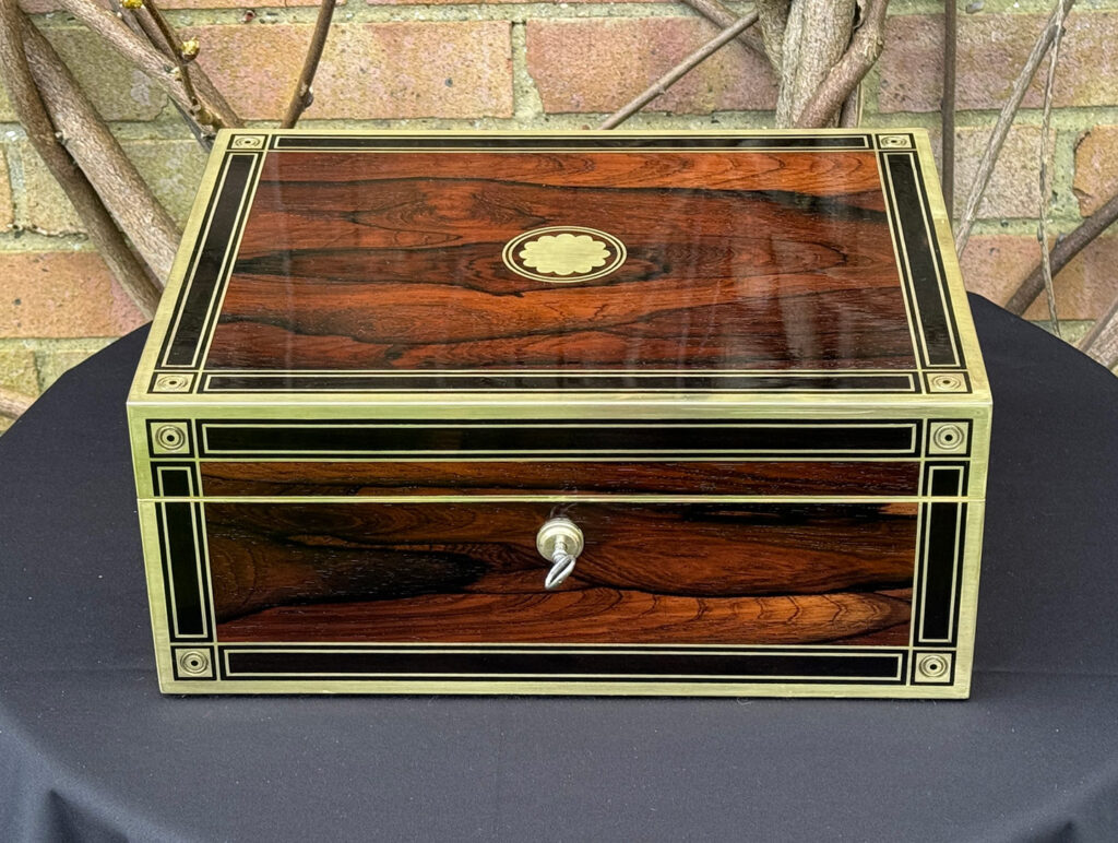Front view of an Antique Jewellery Box in Rosewood with Ebony and Brass Inlay.