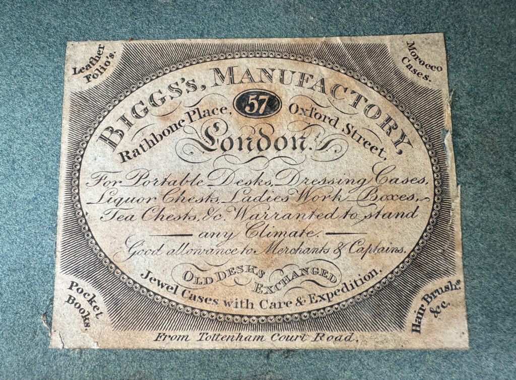 Close up of the makers label from an Antique Jewellery Box in Rosewood with Ebony and Brass Inlay.