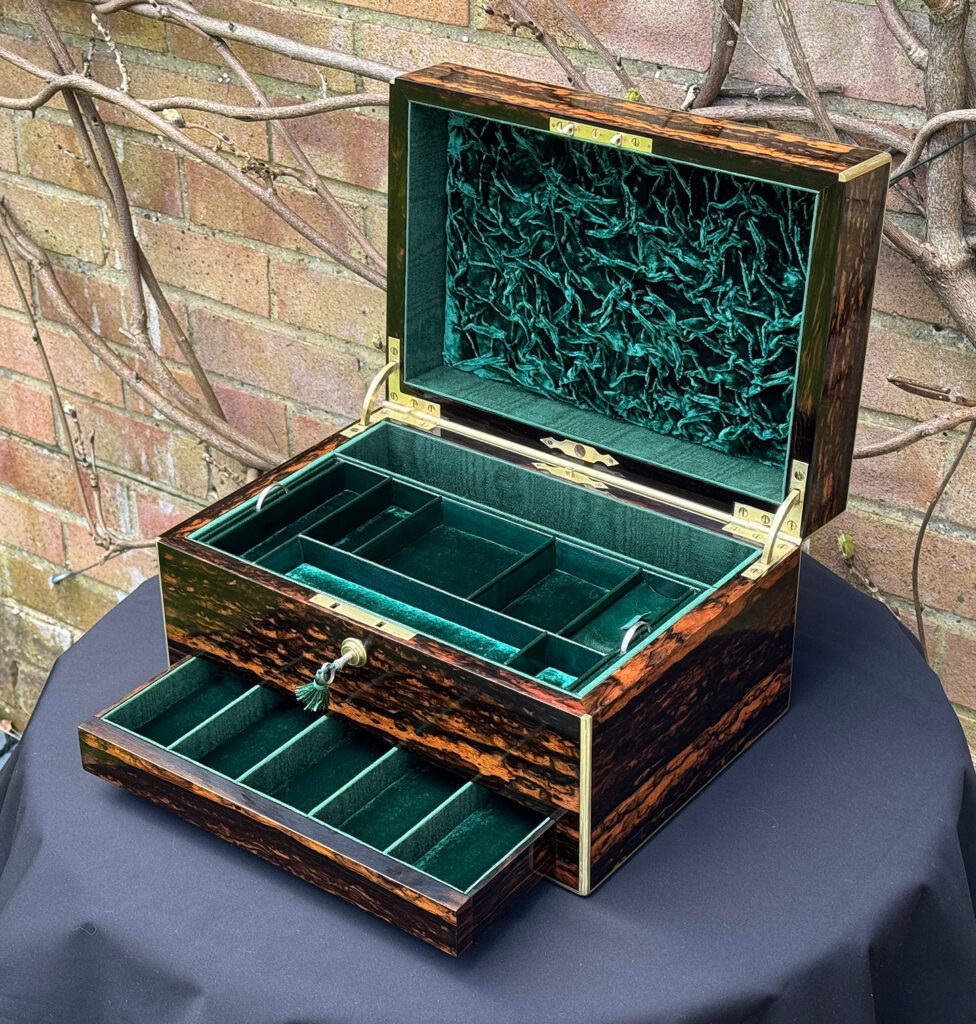 Front right internal view of an Antique Jewellery Box in Coromandel, by Halstaff and Hannaford with lower drawer open.