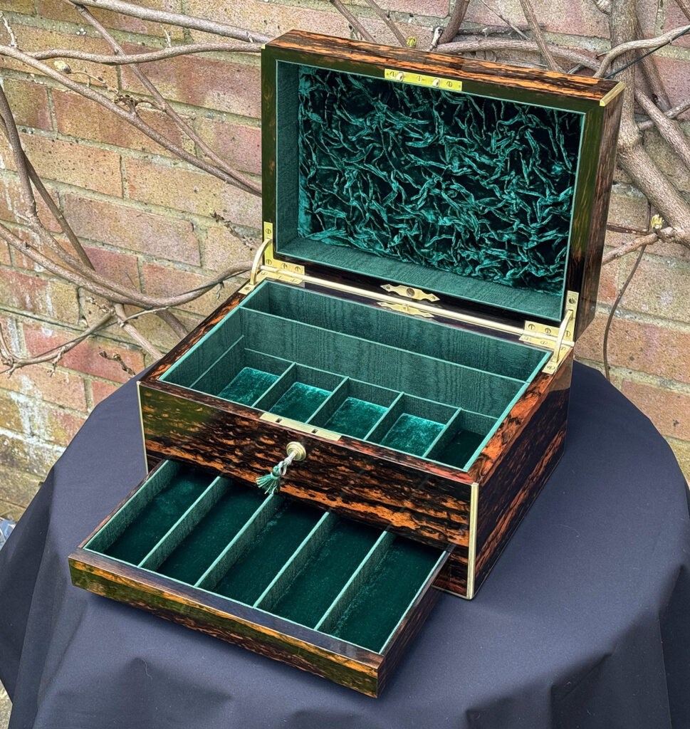 Front right internal view of an Antique Jewellery Box in Coromandel, by Halstaff and Hannaford with lower drawer open.