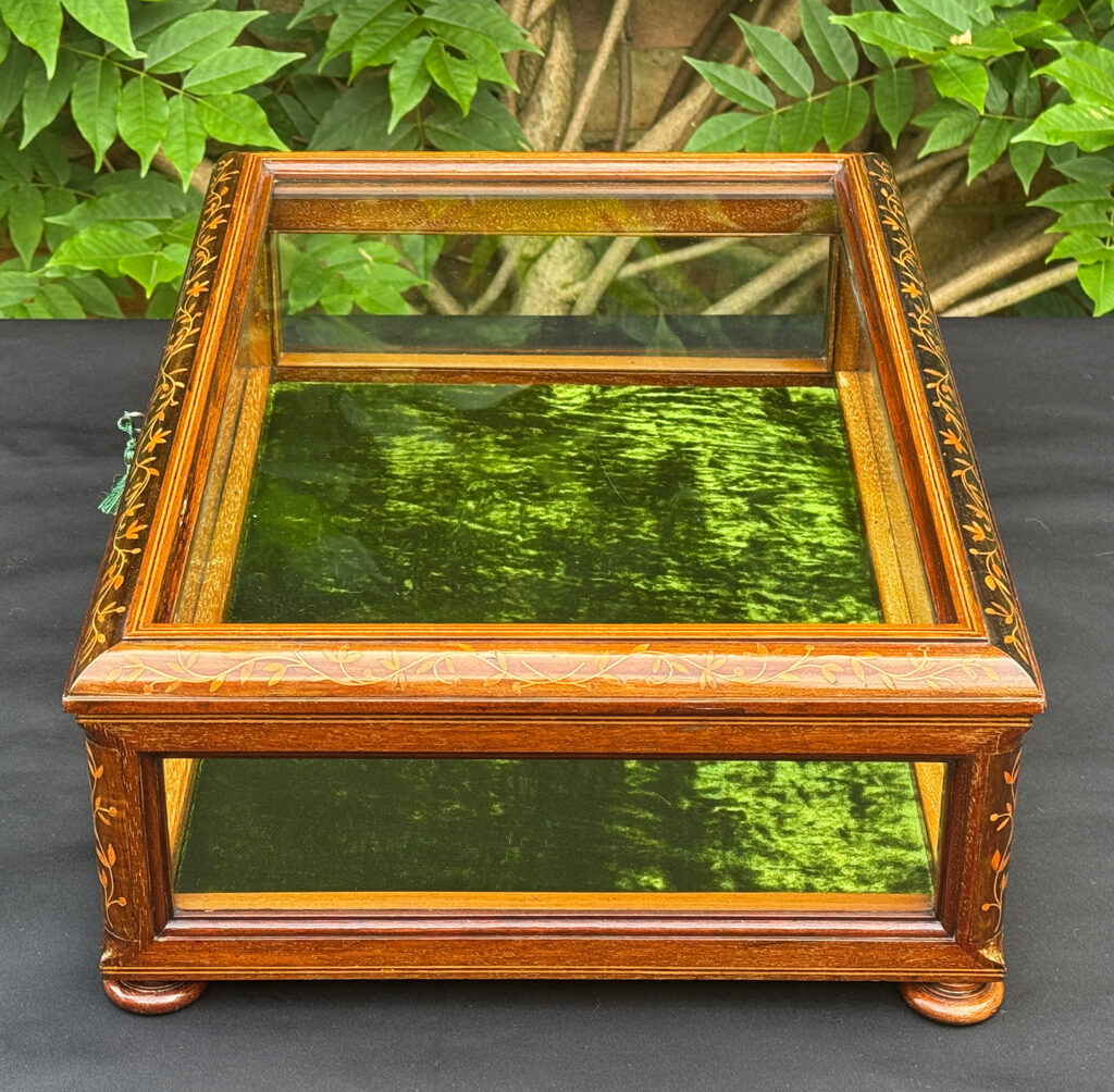 Left side overhead view of an Antique Mahogany Glass Display Case with Foliate Marquetry Inlay.
