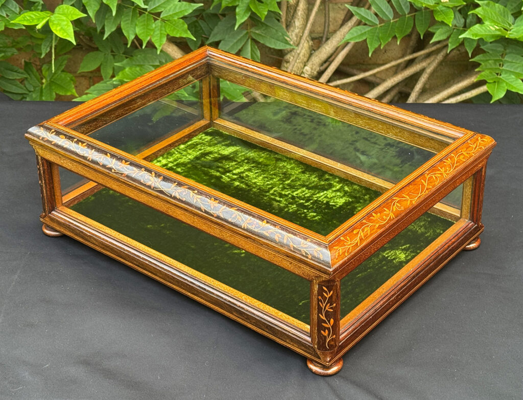 Front left view of an Antique Mahogany Glass Display Case with Foliate Marquetry Inlay.