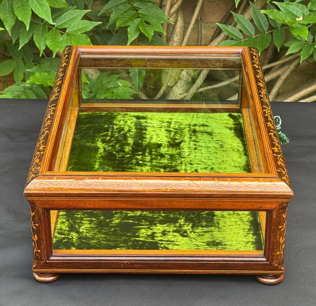 Left side view of an Antique Mahogany Glass Display Case with Foliate Marquetry.