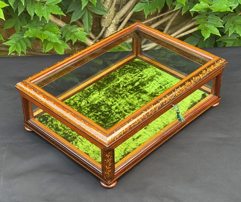 Front right overhead view of an Antique Mahogany Glass Display Case with Foliate Marquetry Inlay.