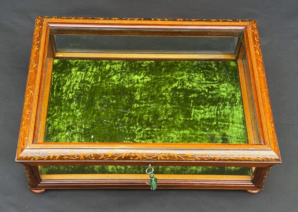 Overhead view of an Antique Mahogany Glass Display Case with Foliate Marquetry Inlay.
