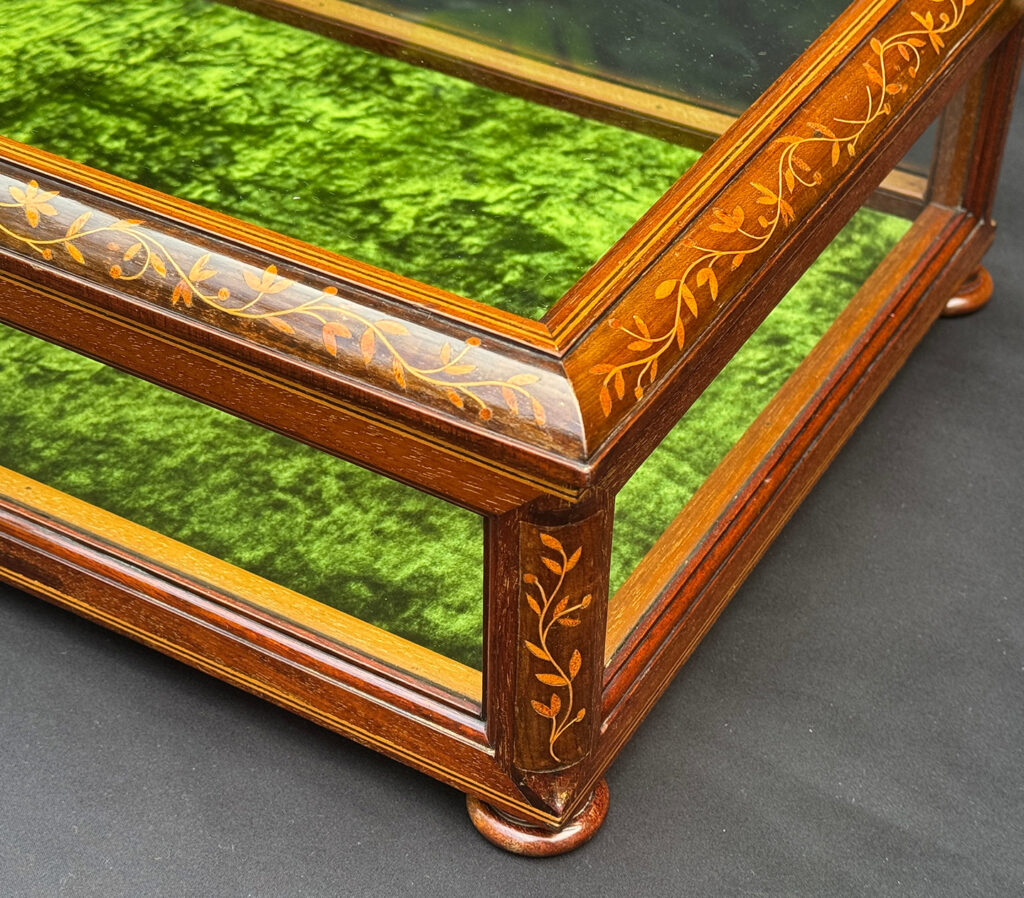 Close up of marquetry from an Antique Mahogany Glass Display Case with Foliate Marquetry Inlay.