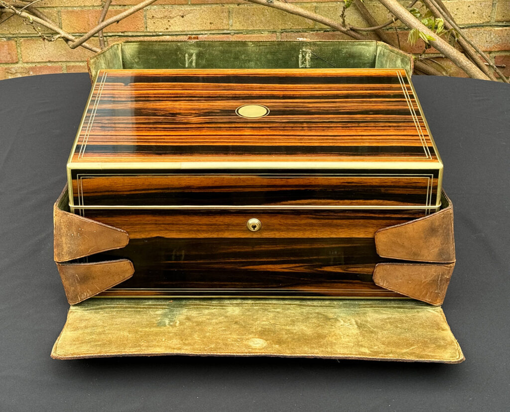 Overhead view of an Extra Large Antique Expanding Jewellery Box in Calamander in its leather outer case.