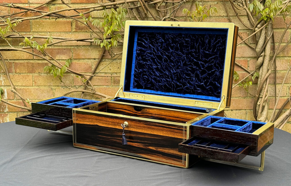 Lower front internal view of an Extra Large Antique Expanding Jewellery Box in Calamander with side trays and concealed drawers fully opened out.