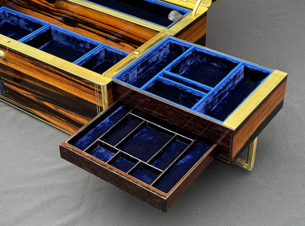 Close up of the right side tray and concealed drawer from an Extra Large Antique Expanding Jewellery Box in Calamander.