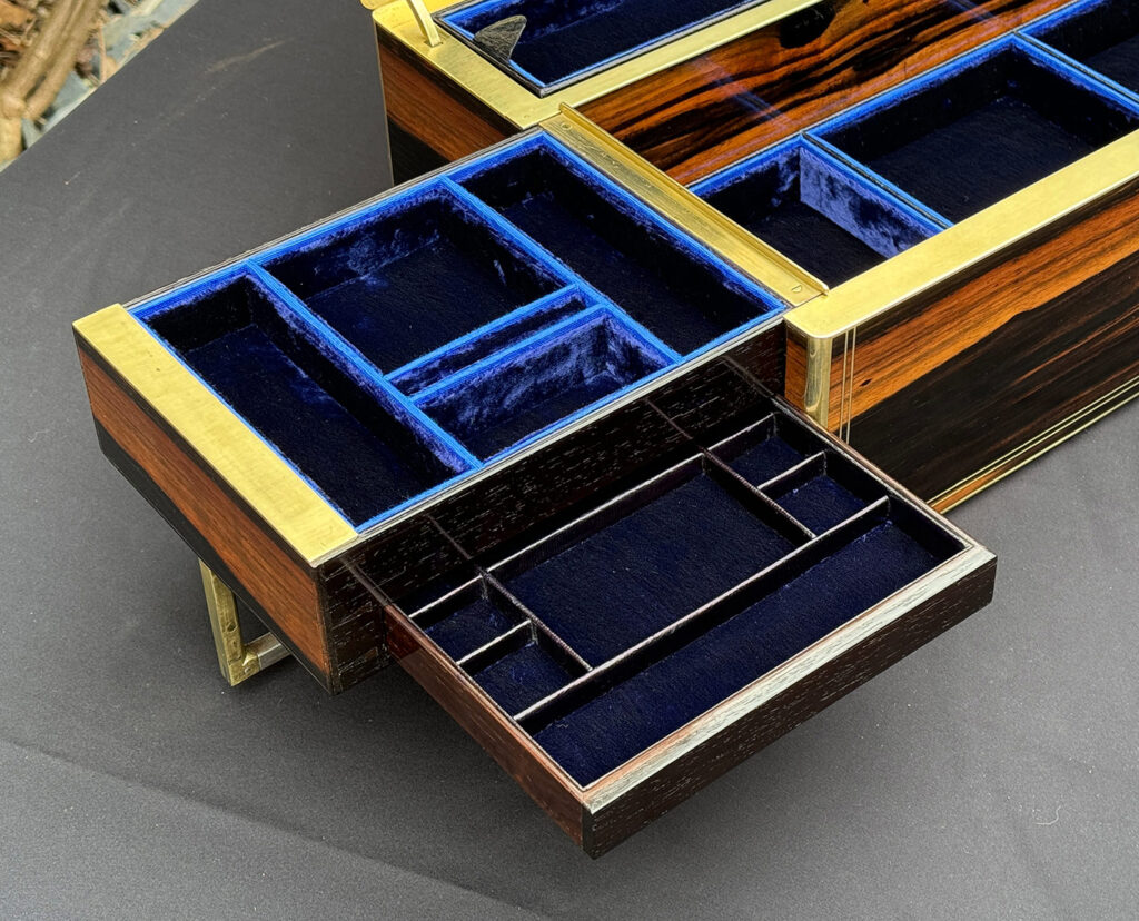 Close up of the left side tray and concealed drawer from an Extra Large Antique Expanding Jewellery Box in Calamander.