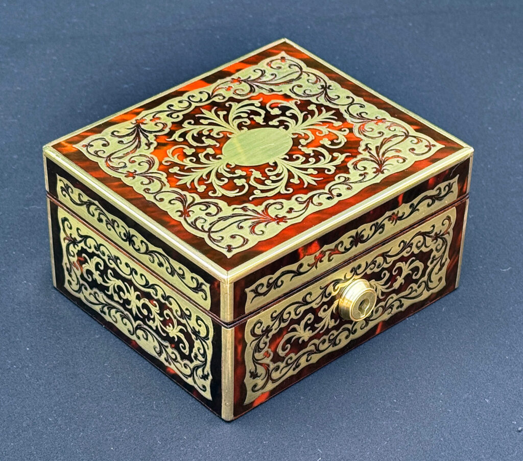 Front left view of an Antique Miniature Boulle Jewellery Box with Bramah Lock.
