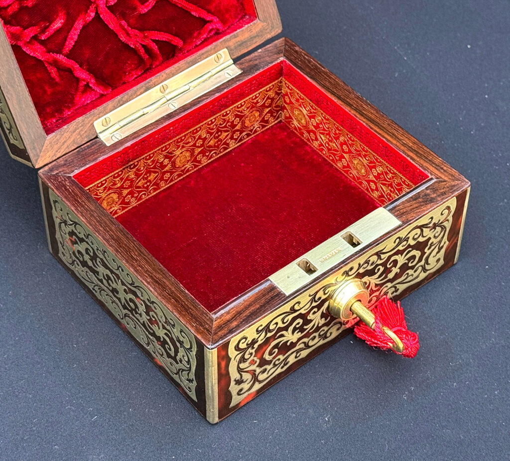 Left overhead internal view of an Antique Miniature Boulle Jewellery Box with Bramah Lock.