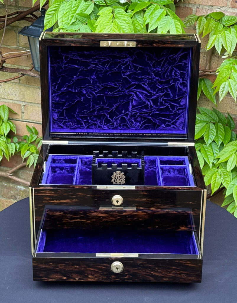Front internal view of an Antique Jewellery Box in Coromandel, by Asprey with lower drawer open.