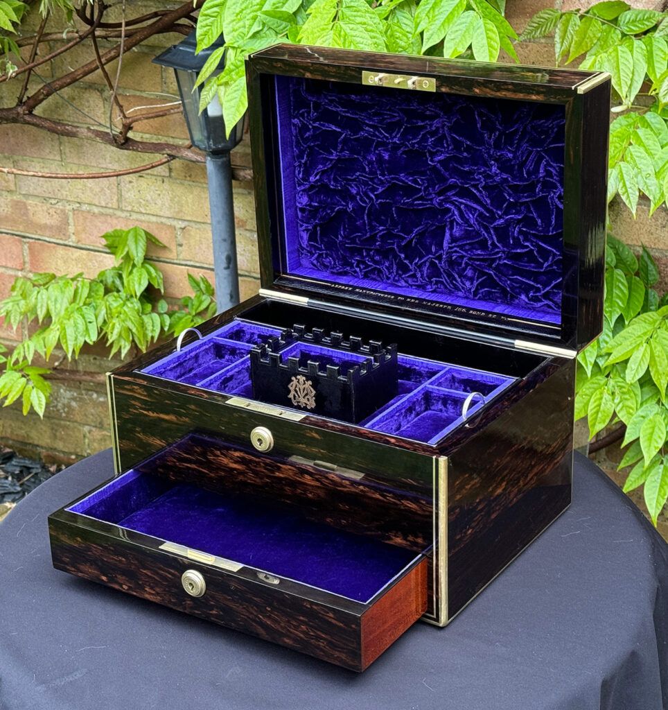 Front right internal view of an Antique Jewellery Box in Coromandel, by Asprey with lower drawer open.