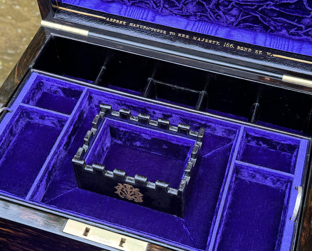 Close up angled view of the castellated interior section from an Antique Jewellery Box in Coromandel, by Asprey.