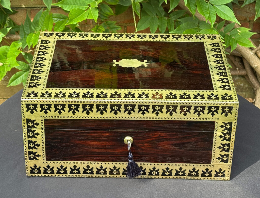 Front view of an Antique Jewellery Box in Rosewood with Decorative Brass Inlay.