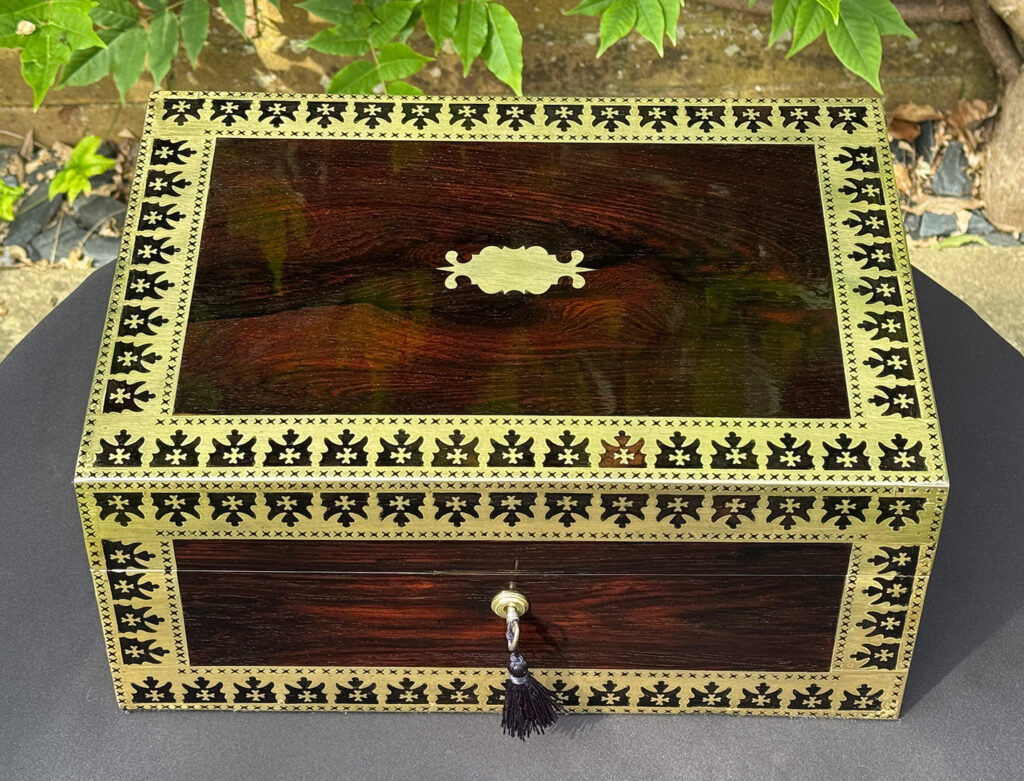 Overhead view of an Antique Jewellery Box in Rosewood with Decorative Brass Inlay.