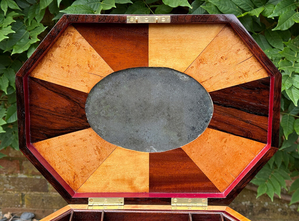 Close up view of the lid underside of a Large Antique Octagonal Jewellery Box with Parquetry Inlay.