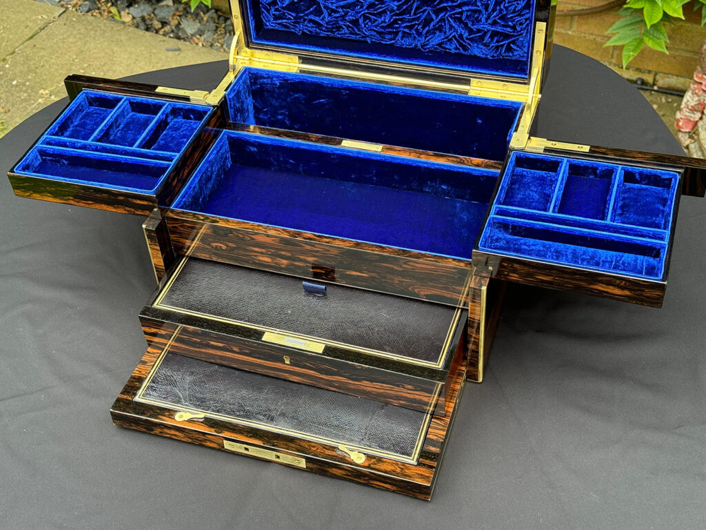 Closer view of a Large Antique Jewellery Box in Coromandel with Cantilever Mechanism with side trays and lower drawer opened.