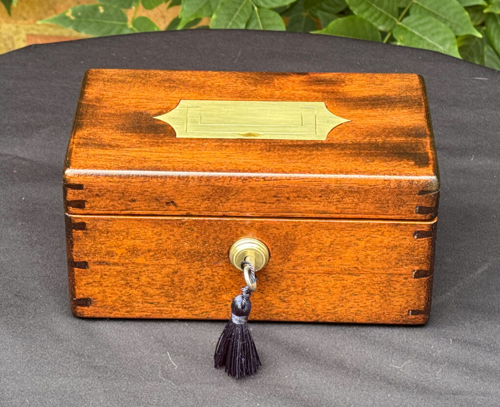 Front view of a Miniature Antique Jewellery Box in Mahogany with Bramah Lock.