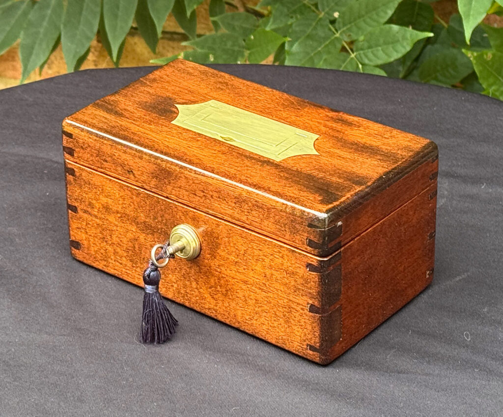 Front right view of a Miniature Antique Jewellery Box in Mahogany with Bramah Lock.
