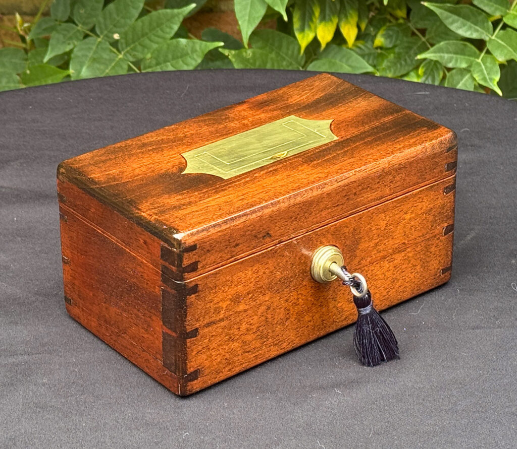 Front left view of a Miniature Antique Jewellery Box in Mahogany with Bramah Lock.