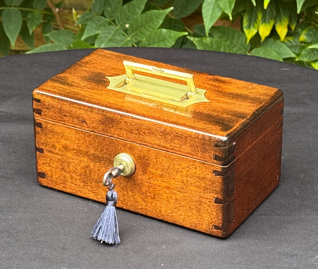 Front right view of a Miniature Antique Jewellery Box in Mahogany with Bramah Lock.