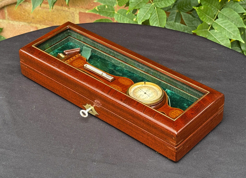 Front right view of an Antique Salesman Sample Miniature 9.5” Barometer in Original Display Case.