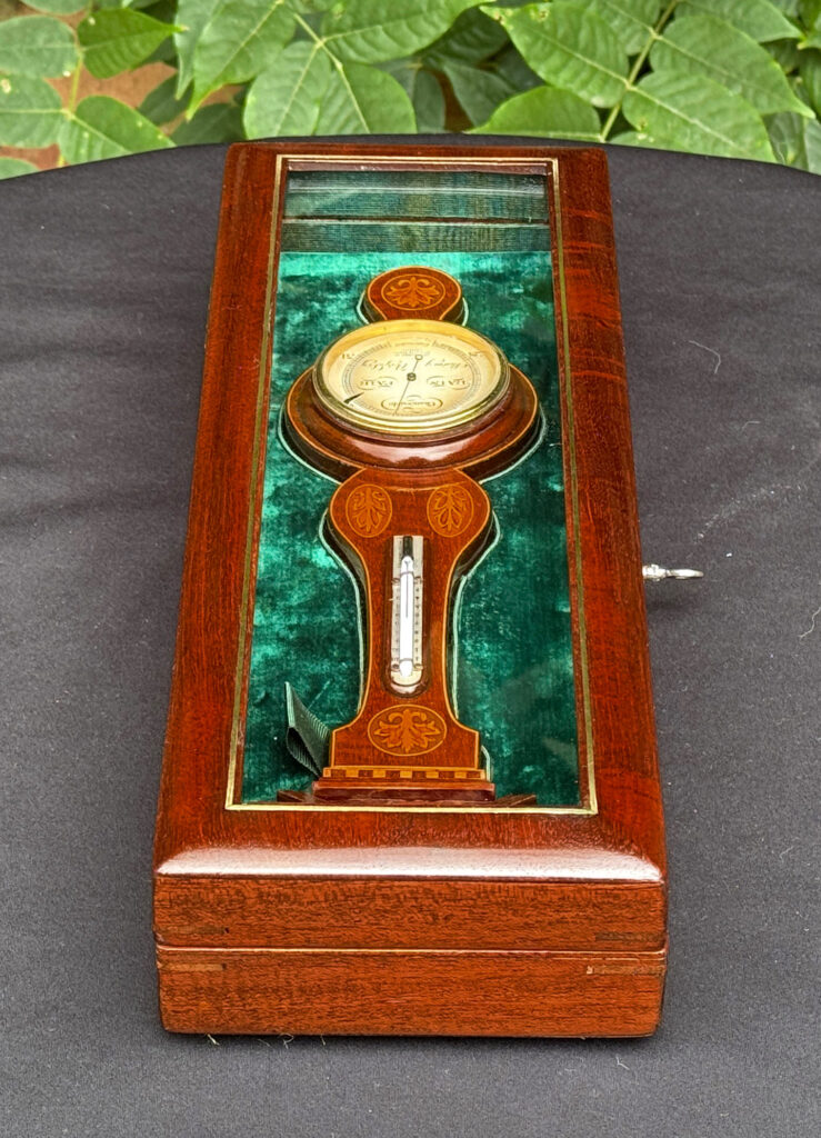 Left side view of an Antique Salesman Sample Miniature 9.5” Barometer in Original Display Case.