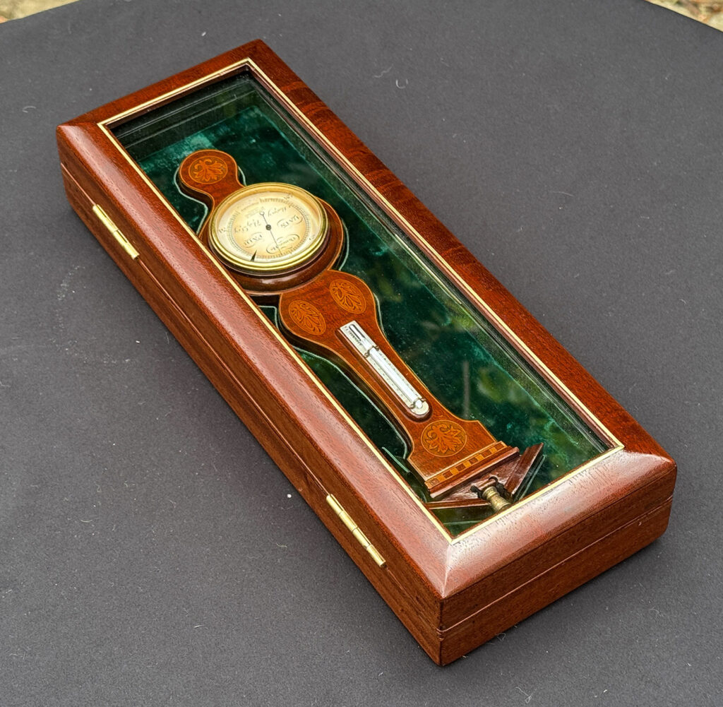 Rear left overhead view of an Antique Salesman Sample Miniature 9.5” Barometer in Original Display Case.