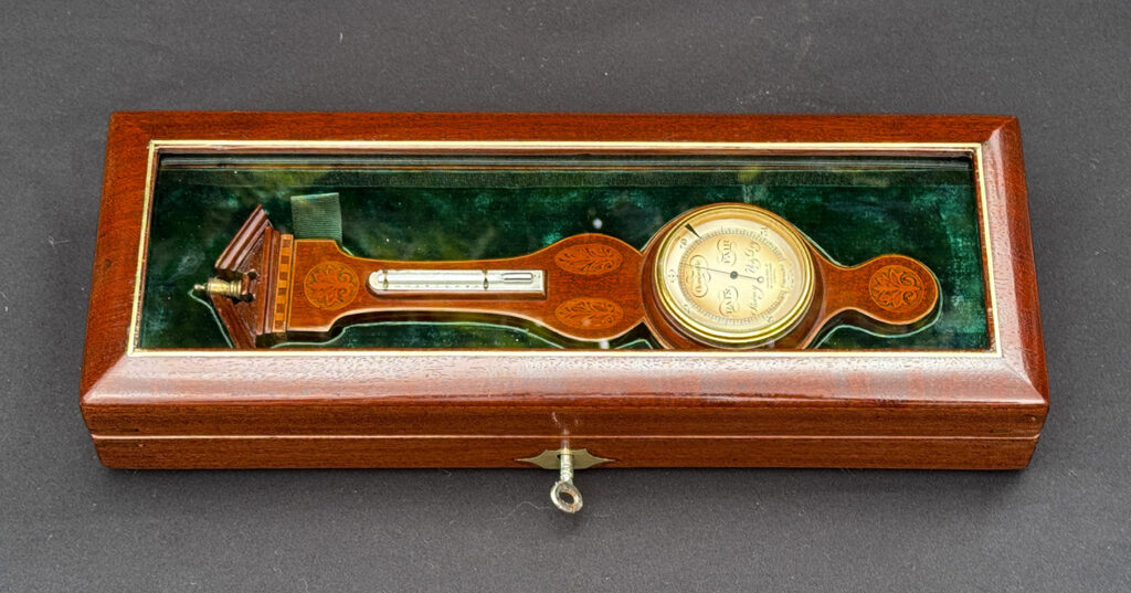 Front overhead view of an Antique Salesman Sample Miniature 9.5” Barometer in Original Display Case.