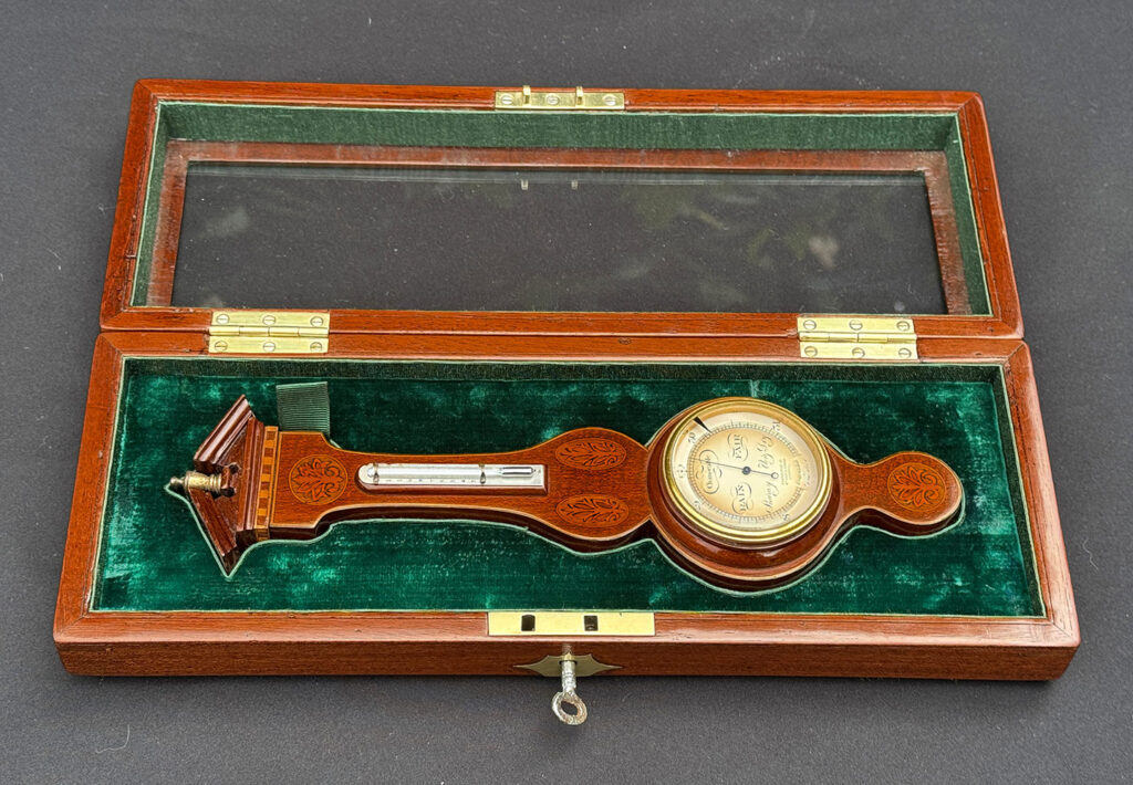 Front overhead view of an Antique Salesman Sample Miniature 9.5” Barometer in Original Display Case.