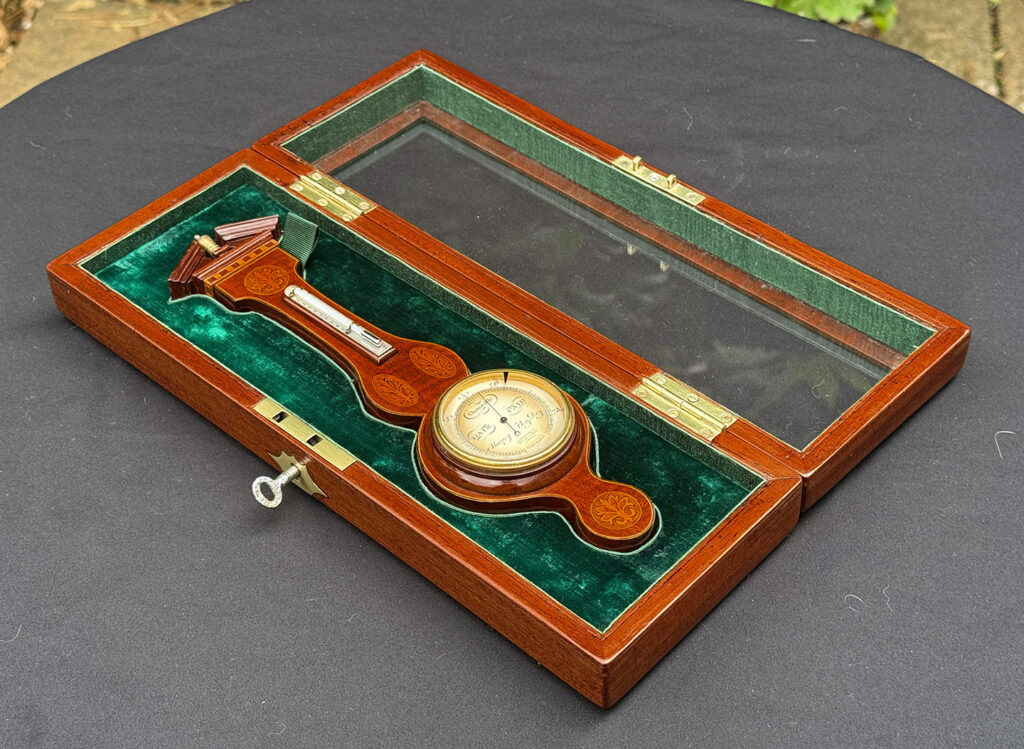 Full view of an Antique Salesman Sample Miniature 9.5” Barometer fitted within its display case.